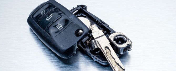 Key fob with an open battery compartment, showing the newly replaced battery