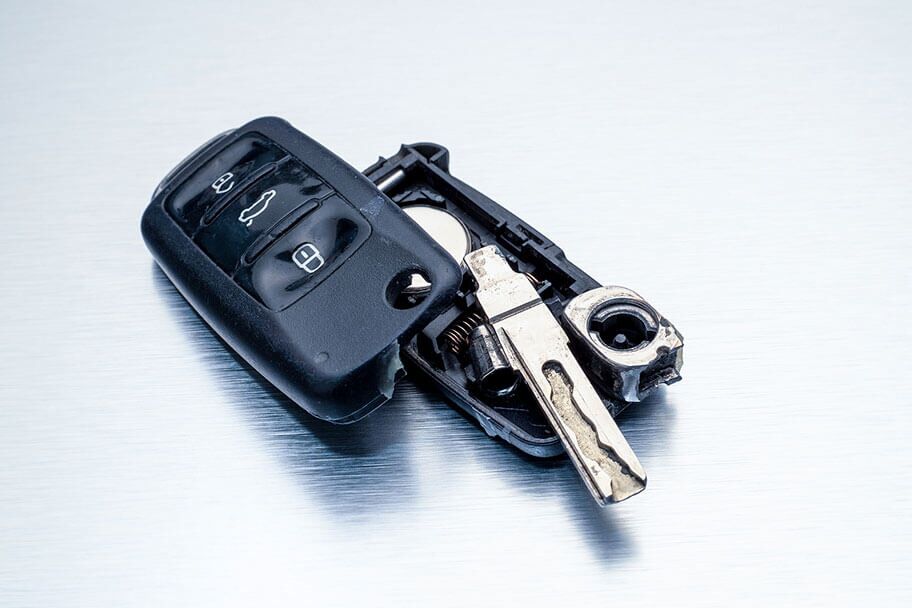Key fob with an open battery compartment, showing the newly replaced battery